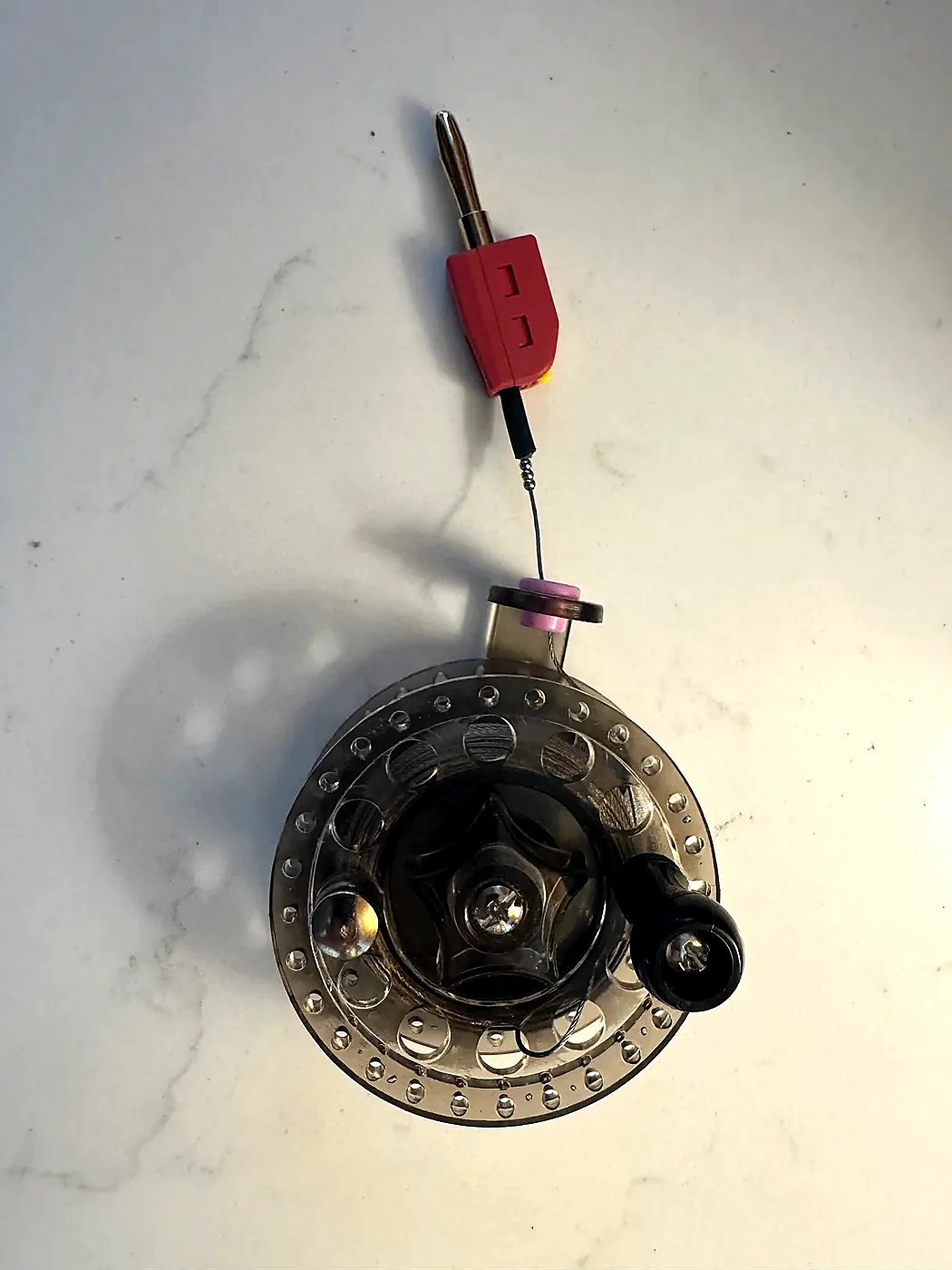Completed reelable counterpoise with a red four-millimeter banana plug installed on the wire