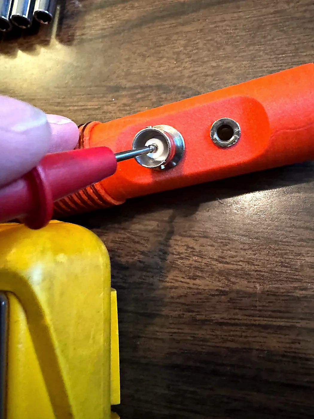 Soldering iron joining the coil lead to the BNC center contact