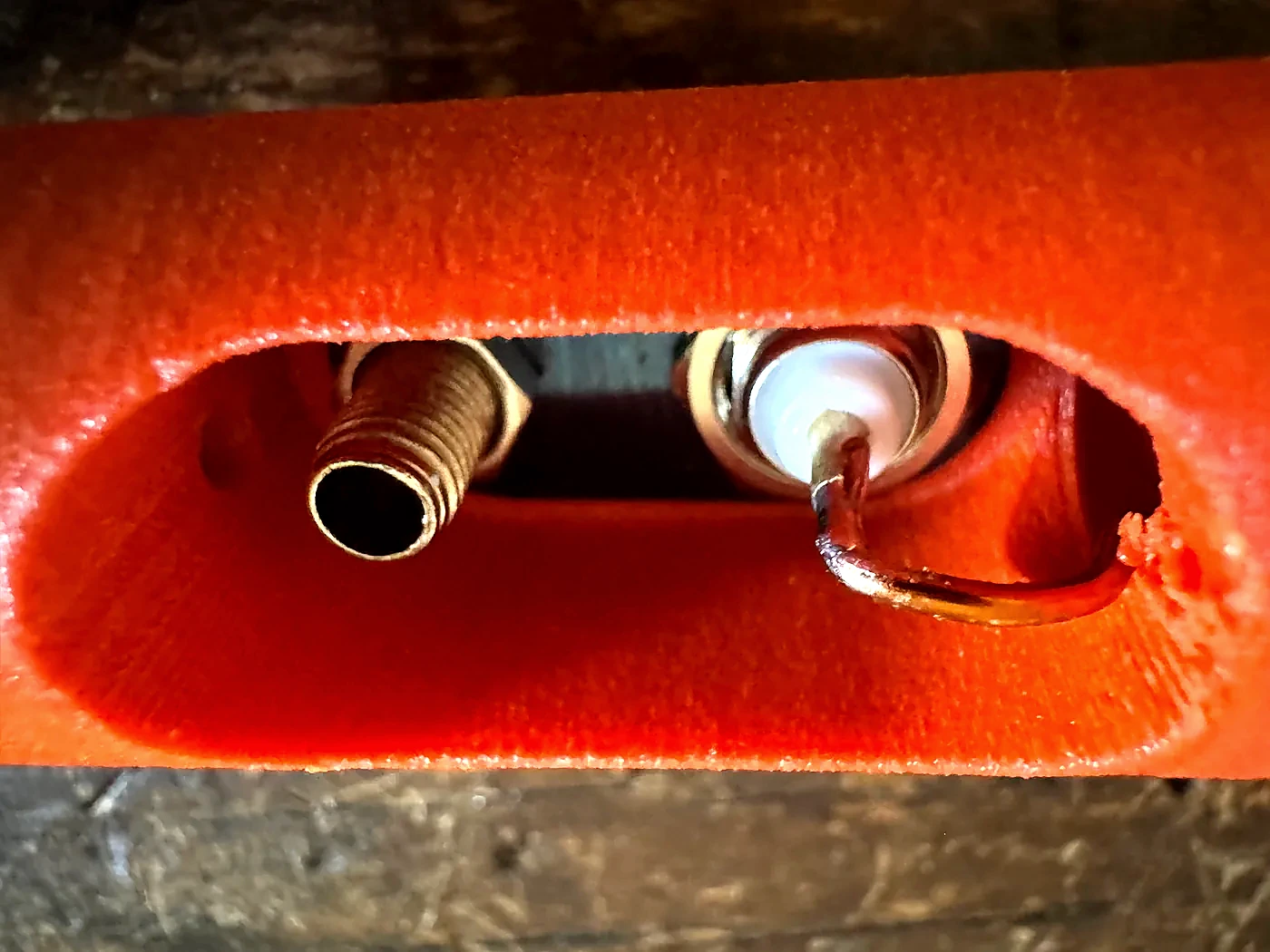 Close-up through the Hamdo access opening showing the completed solder joint and connector hardware