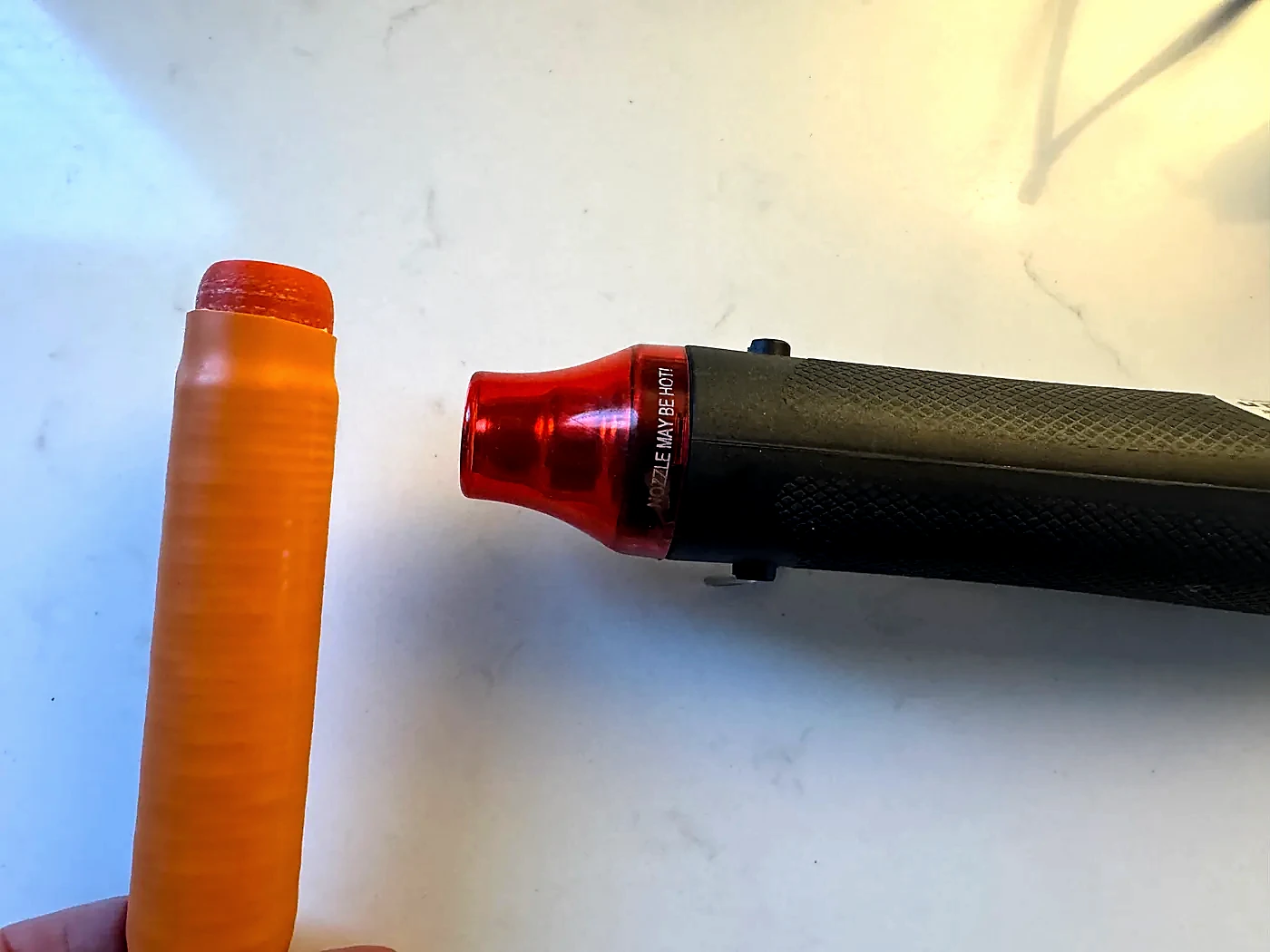 Heat gun shrinking orange marine-grade tubing over the Hamdo loading coil